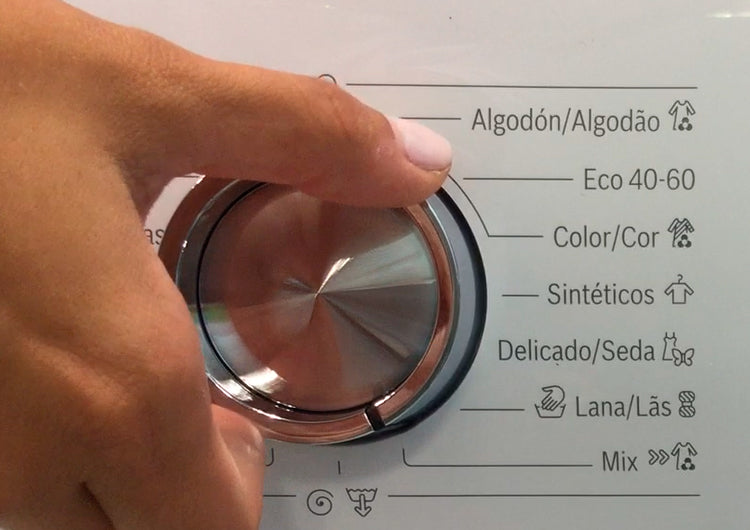 Hand selecting a washing machine program